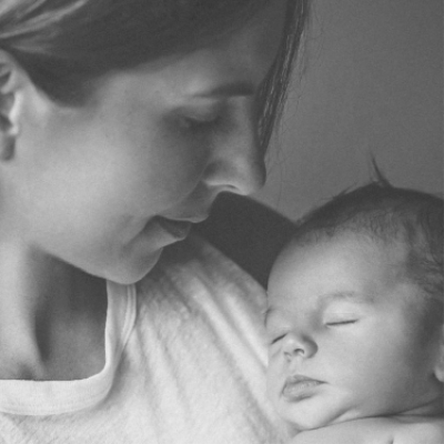 Black and white picture of woman holding a baby.